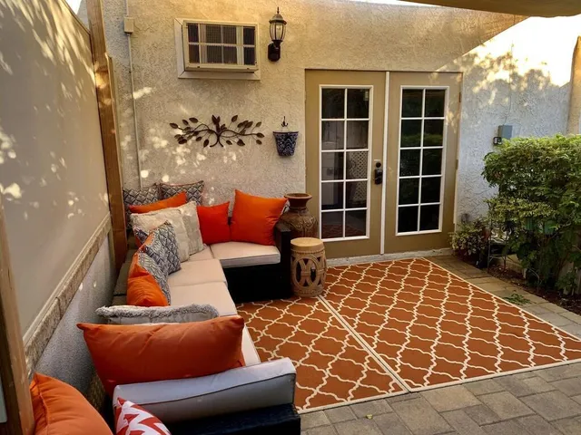 a outdoor space with blue couches and a potted plant on a table