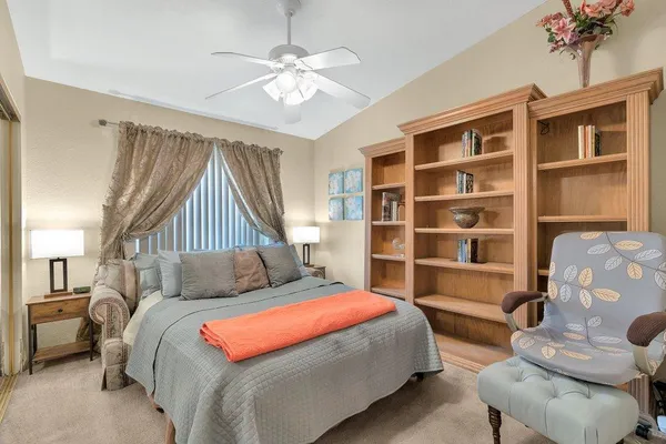 a bedroom with a large bed and a chandelier