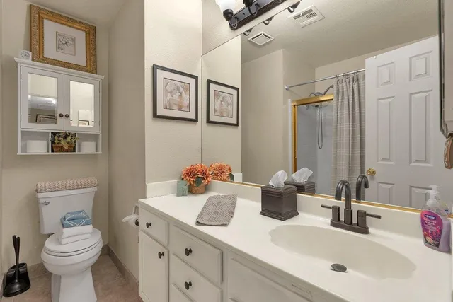 a bathroom with double sink and a toilet