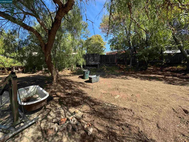 a backyard of a house with fire pit and outdoor seating