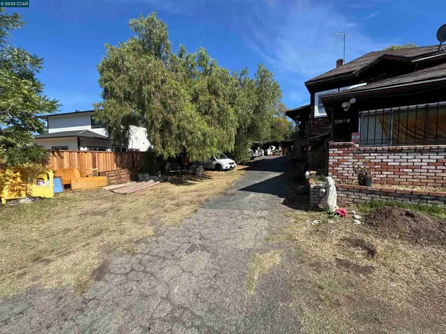 a view of street and wooden fence