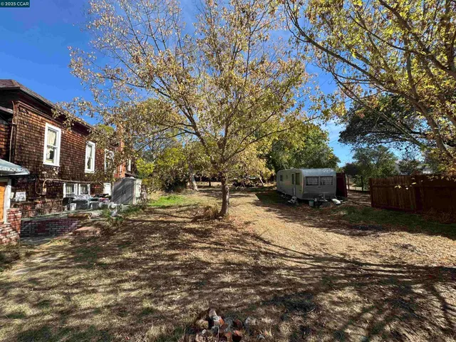 a view of street with large trees