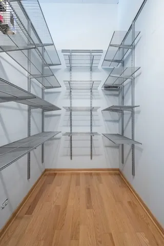 a view of walk in closet with empty racks