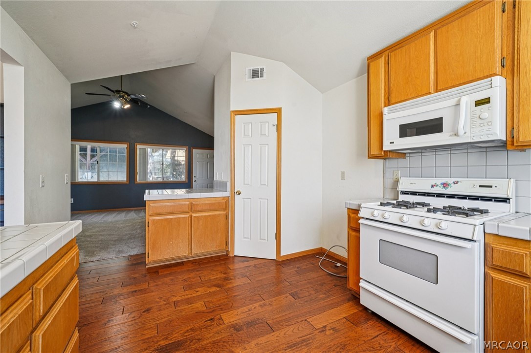 25274 N Road Twin Peaks, CA 92391 - Photo 11 of 41 a kitchen with stainless steel appliances granite countertop a stove a sink and a microwave