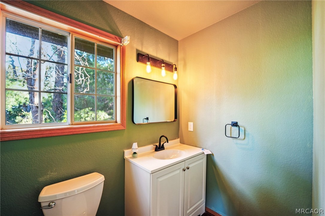25274 N Road Twin Peaks, CA 92391 - Photo 12 of 41 a bathroom with a toilet sink and mirror