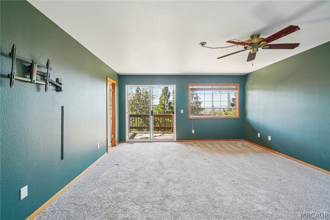 25274 N Road Twin Peaks, CA 92391 - Photo 16 of 41 a view of a livingroom with a ceiling fan and windows