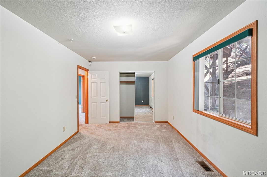 25274 N Road Twin Peaks, CA 92391 - Photo 23 of 41 an empty room with windows