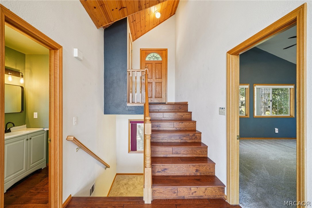 25274 N Road Twin Peaks, CA 92391 - Photo 5 of 41 a view of a hallway with wooden floor and staircase