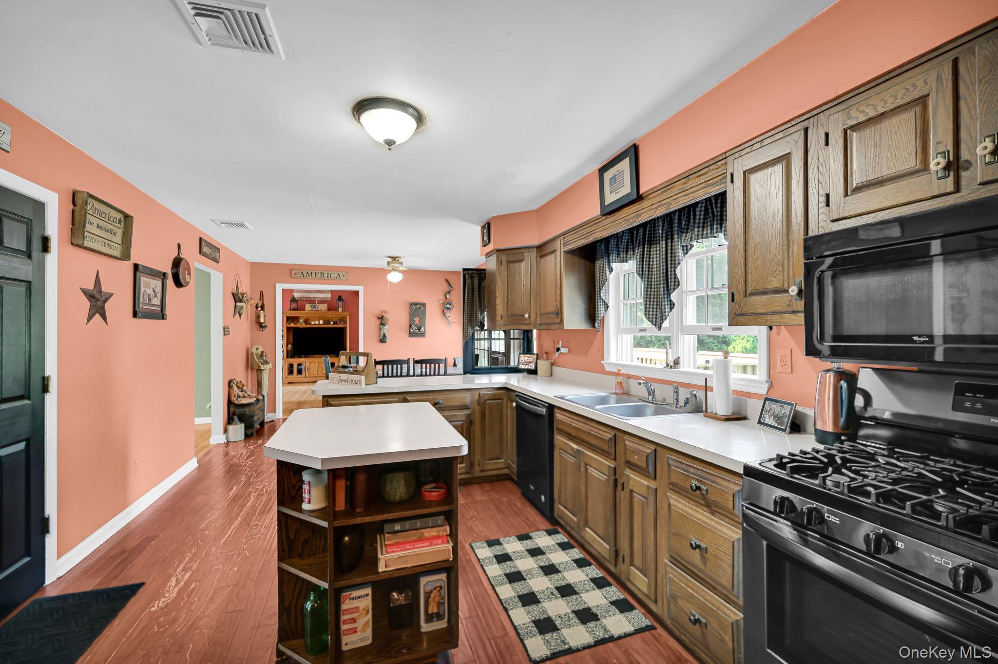 28 Brady Road Warwick, NY 10990 - Photo 18 of 50 a kitchen with stainless steel appliances a stove a sink dishwasher and cabinets with wooden floor