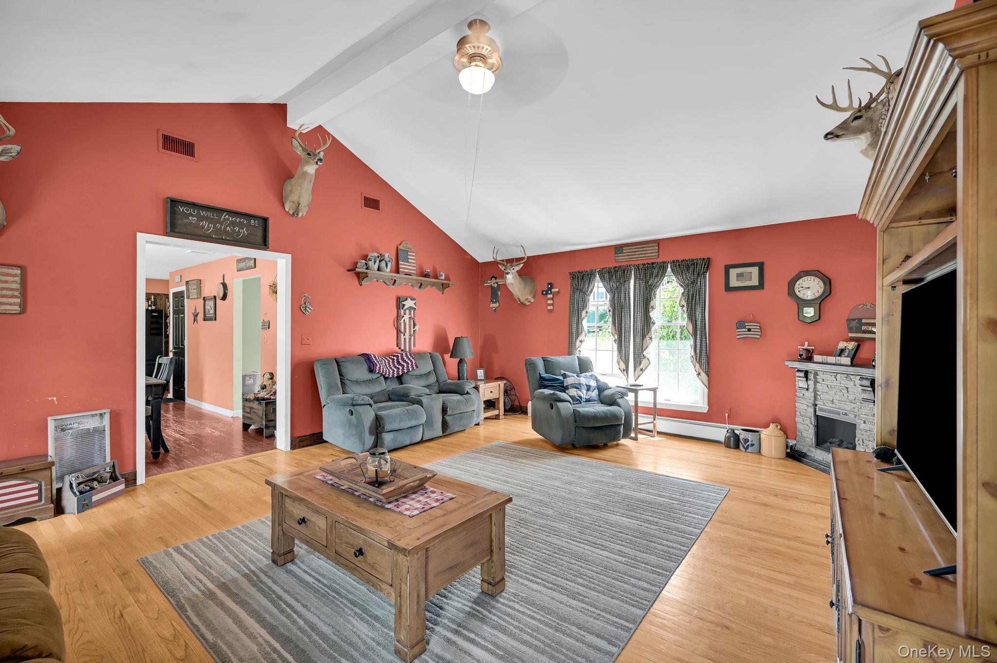28 Brady Road Warwick, NY 10990 - Photo 21 of 50 a living room with furniture a flat screen tv and a large window