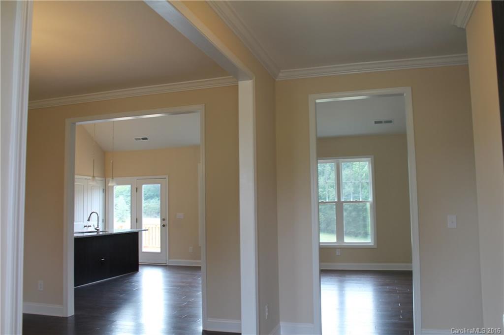 4216 Sincerity Road, Unit 1 Monroe, NC 28110 - Photo 4 of 21 a view of a hallway with wooden floor and windows