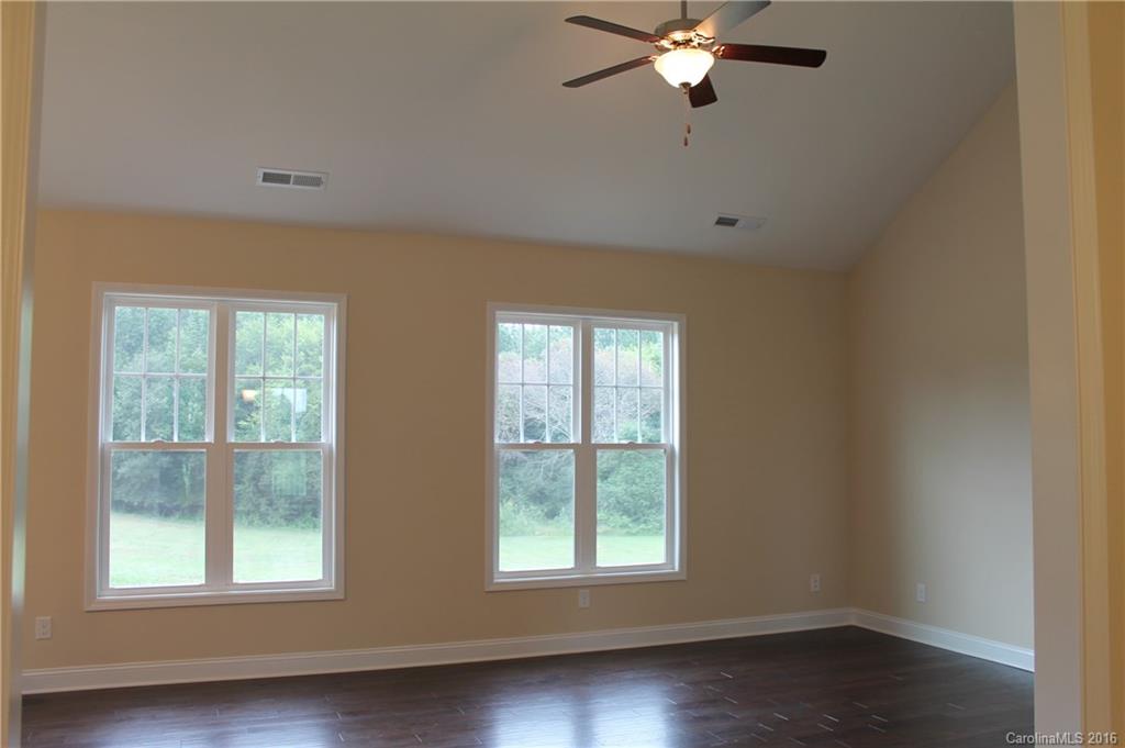 4216 Sincerity Road, Unit 1 Monroe, NC 28110 - Photo 5 of 21 a view of an empty room with wooden floor and a window