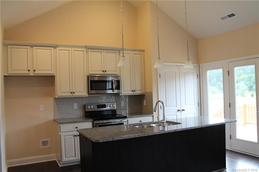 4216 Sincerity Road, Unit 1 Monroe, NC 28110 - Photo 8 of 21 a kitchen with stainless steel appliances granite countertop a sink a stove and a microwave