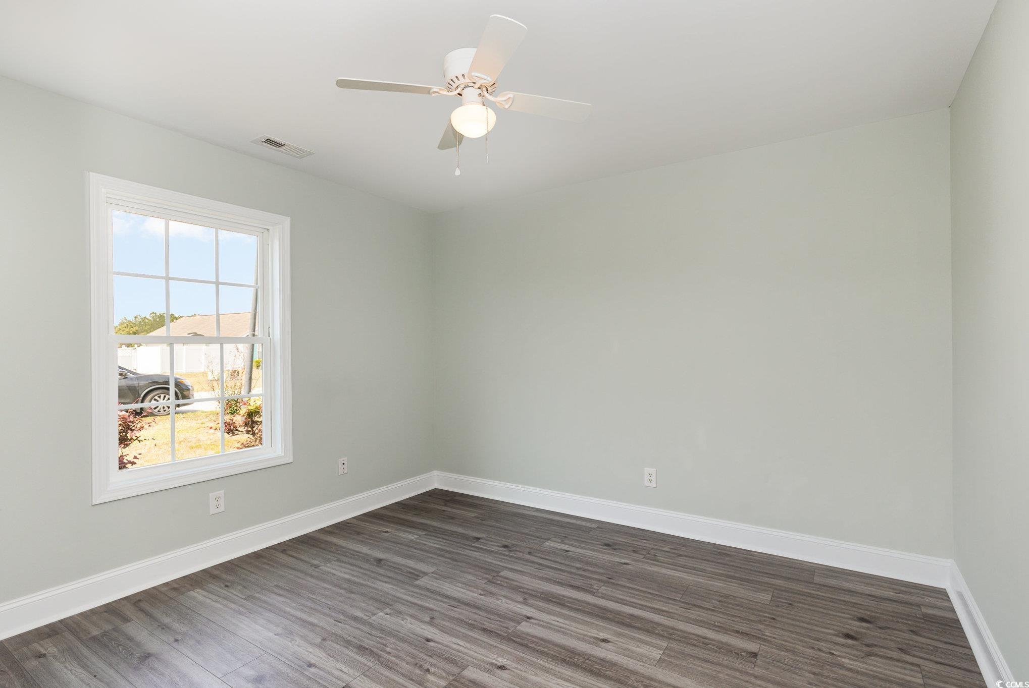 469 Overcrest Street Myrtle Beach, SC 29579 - Photo 12 of 18 Empty room with baseboards, a ceiling fan, dark wo