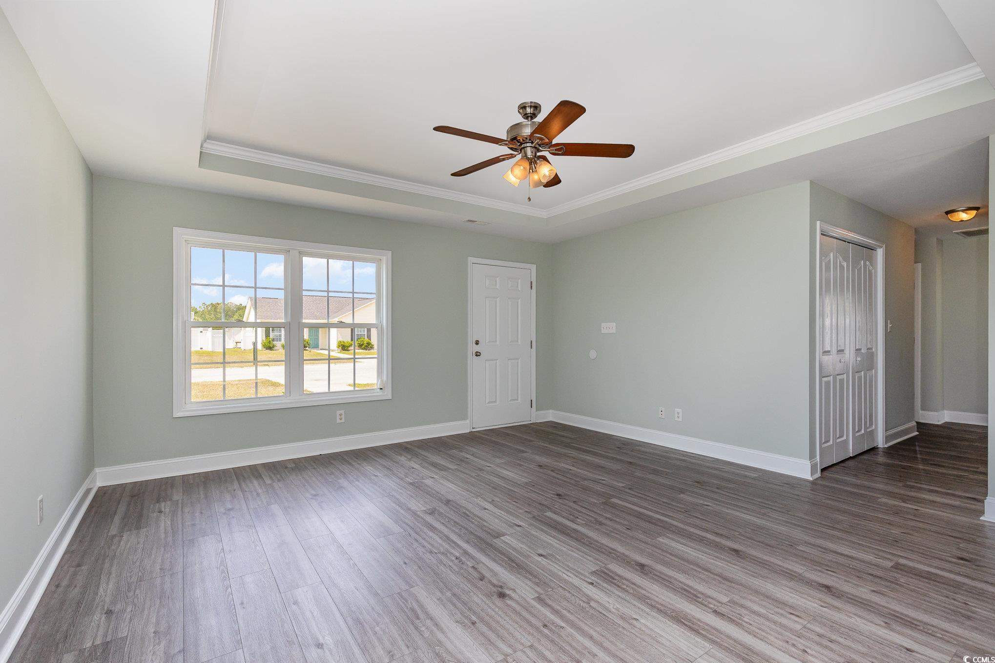 469 Overcrest Street Myrtle Beach, SC 29579 - Photo 3 of 18 Empty room with crown molding, a ceiling fan, base