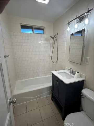 a bathroom with a sink toilet vanity and shower