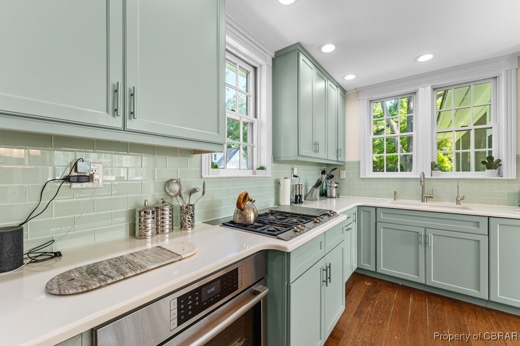 1701 Balls Neck Road Kilmarnock, VA 22482 - Photo 35 of 50 Kitchen featuring backsplash, sink, dark wood-type flooring, and plenty of natural light