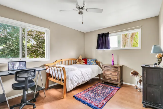 a bedroom with a bed and a desk