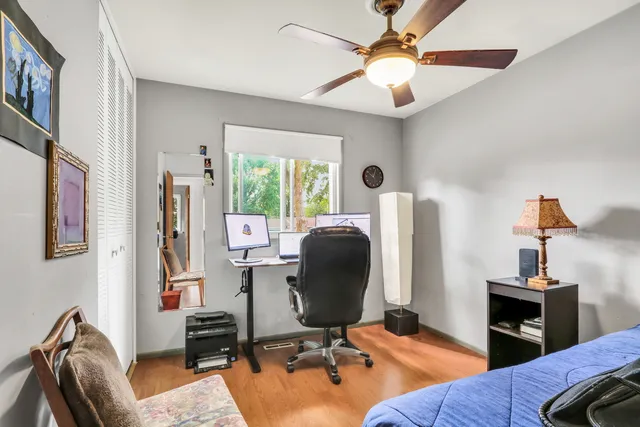 a view of a livingroom with workspace and a window