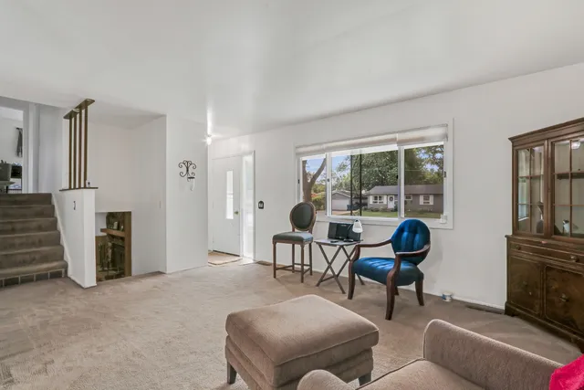 a living room with furniture a fireplace and a window