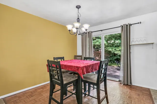 a dining room with furniture and a chandelier