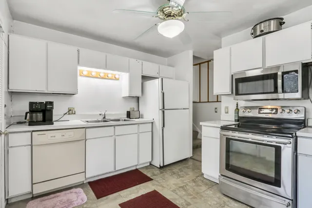 a kitchen with cabinets appliances and a sink