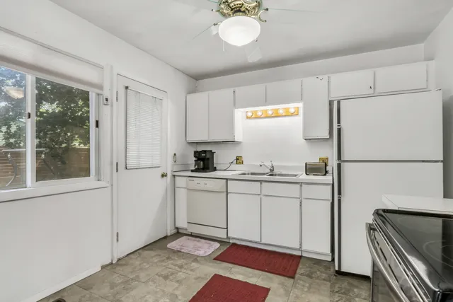 a kitchen with sink cabinets and refrigerator