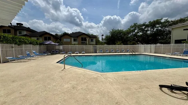 a view of a swimming pool with an outdoor space and seating area