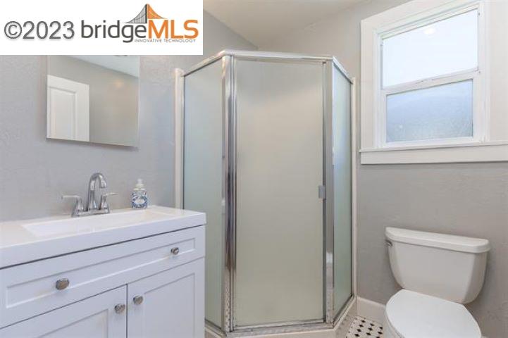 2734 D Street Antioch, CA 94509 - Photo 11 of 15 a bathroom with a toilet sink vanity and mirror