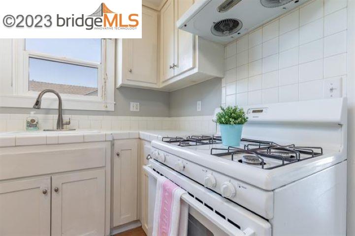 2734 D Street Antioch, CA 94509 - Photo 9 of 15 a white kitchen with stove and cabinets