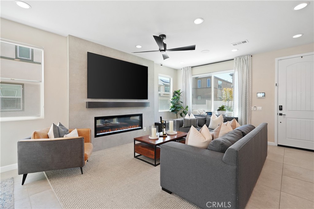 32522 Brunello Way Temecula, CA 92591 - Photo 14 of 75 a living room with furniture a flat screen tv and a fireplace
