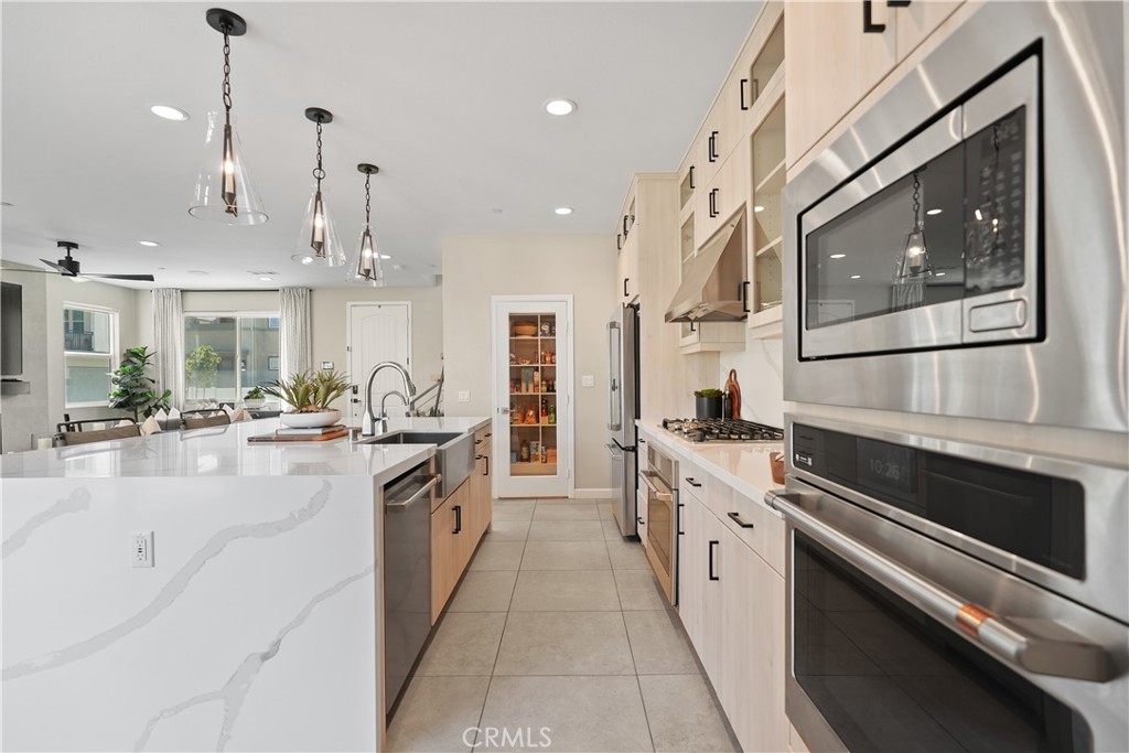 32522 Brunello Way Temecula, CA 92591 - Photo 25 of 75 a large white kitchen with stainless steel appliances granite countertop lots of counter space and wooden floor