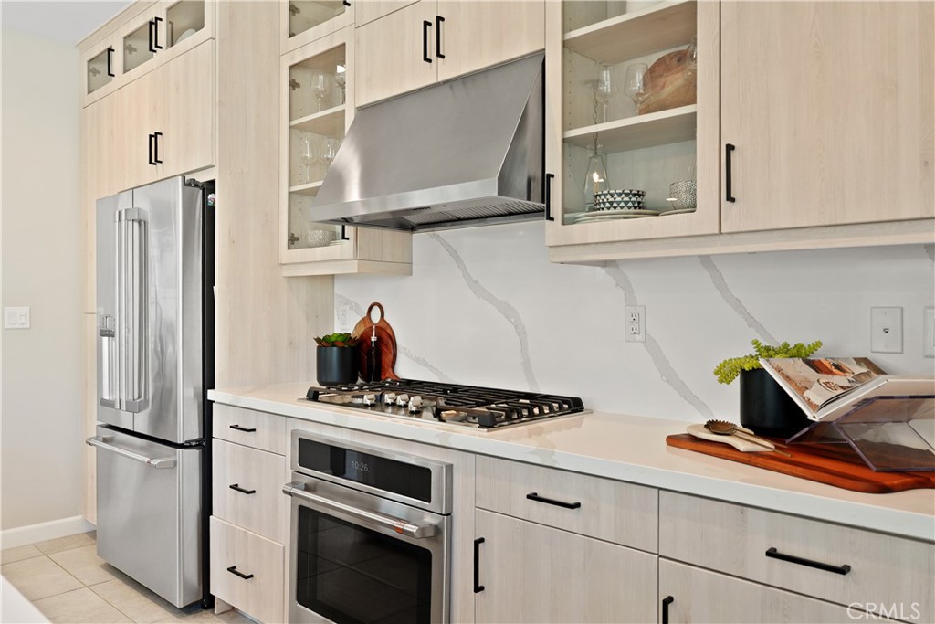 32522 Brunello Way Temecula, CA 92591 - Photo 26 of 75 a kitchen with stainless steel appliances a refrigerator and a stove