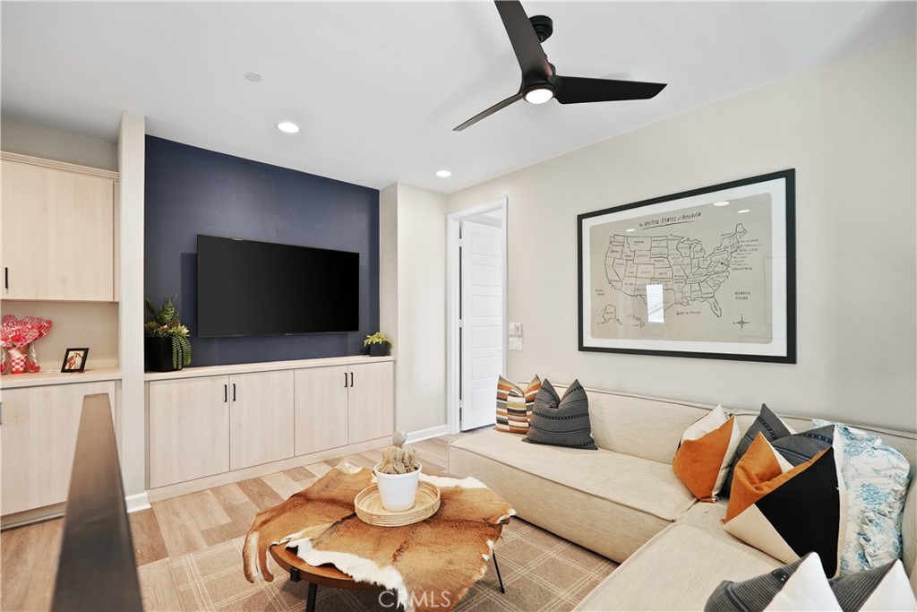 32522 Brunello Way Temecula, CA 92591 - Photo 34 of 75 a living room with furniture and a flat screen tv