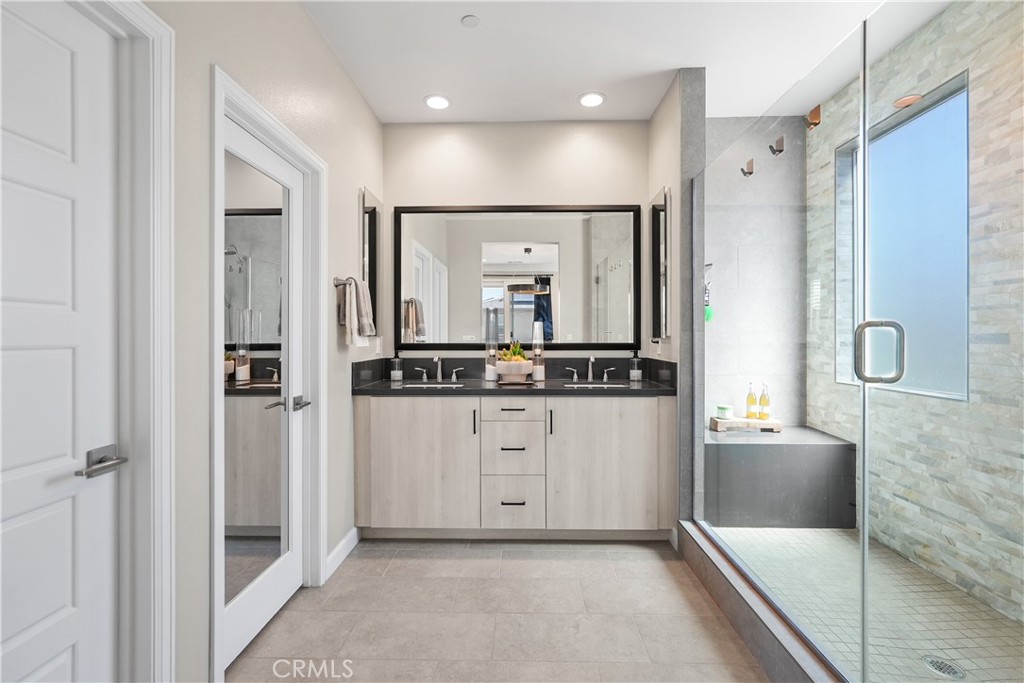 32522 Brunello Way Temecula, CA 92591 - Photo 41 of 75 a bathroom with a double vanity sink mirror and shower