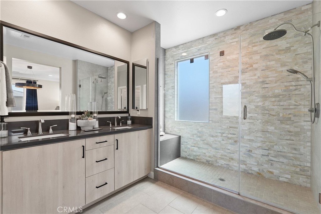 32522 Brunello Way Temecula, CA 92591 - Photo 42 of 75 a bathroom with a double vanity sink and mirror