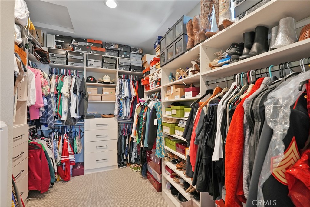 32522 Brunello Way Temecula, CA 92591 - Photo 45 of 75 a view of walk in closet with clothes and shoes