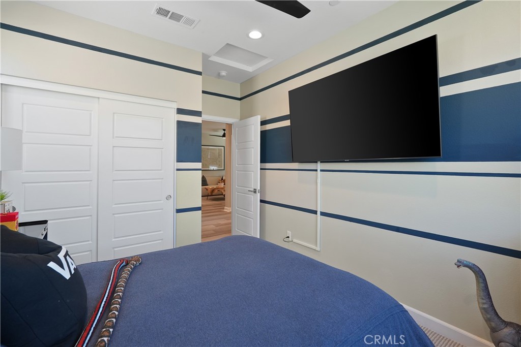 32522 Brunello Way Temecula, CA 92591 - Photo 47 of 75 a bedroom with a bed and a flat screen tv