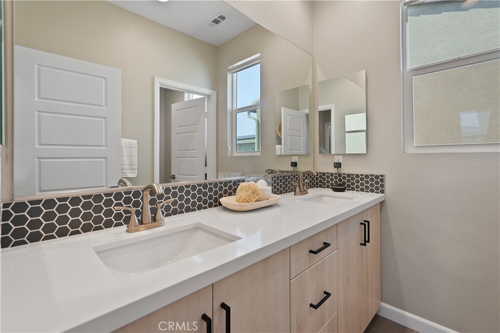 32522 Brunello Way Temecula, CA 92591 - Photo 50 of 75 a bathroom with a sink and a mirror