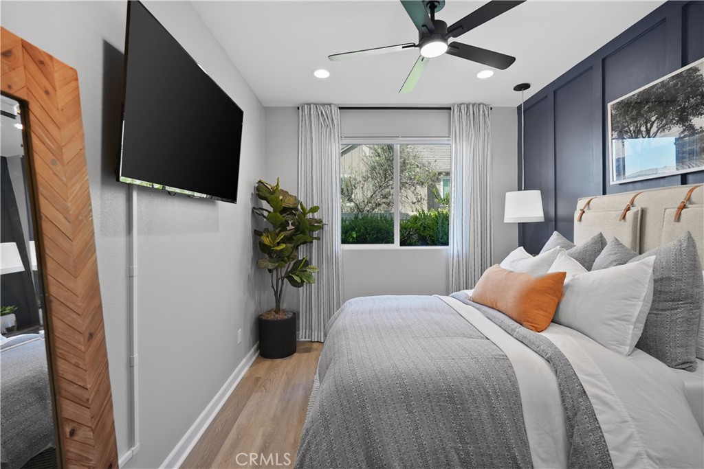 32522 Brunello Way Temecula, CA 92591 - Photo 54 of 75 a bedroom with a bed flat screen tv and a large window