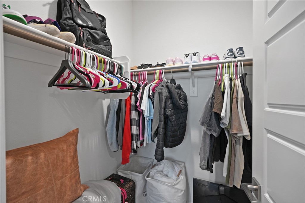 32522 Brunello Way Temecula, CA 92591 - Photo 56 of 75 a view of walk in closet with clothes and shoes
