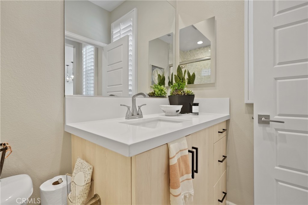 32522 Brunello Way Temecula, CA 92591 - Photo 58 of 75 a bathroom with a sink a toilet and mirror