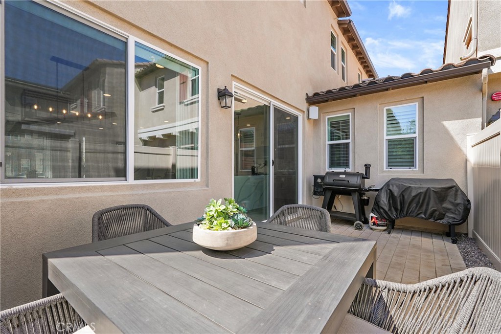 32522 Brunello Way Temecula, CA 92591 - Photo 60 of 75 a view of a patio with couches table and chairs and potted plants