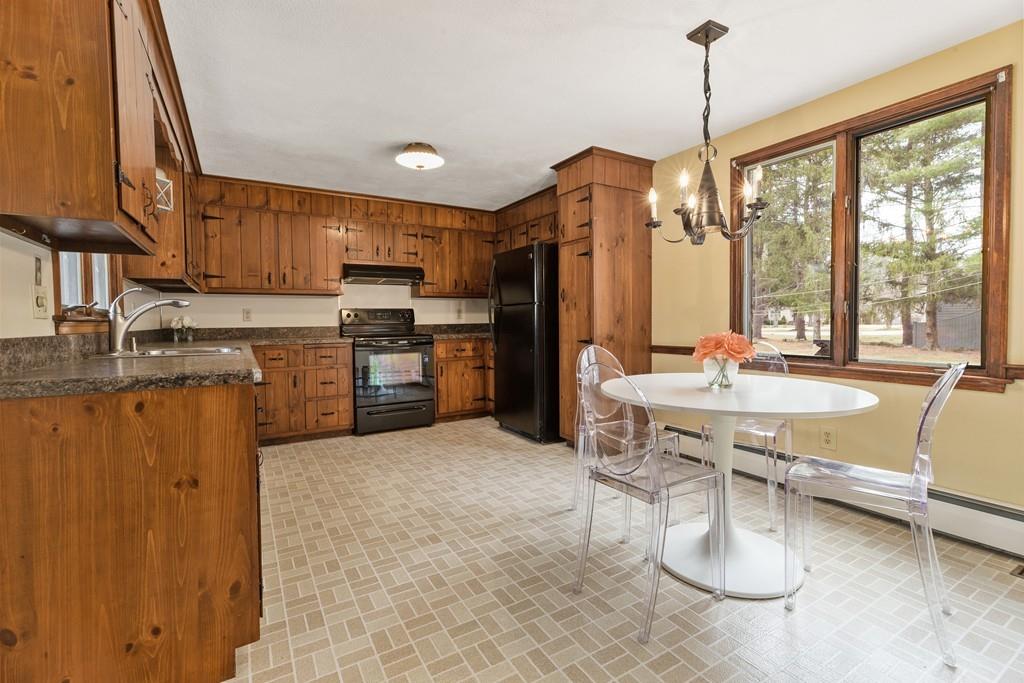 2 Craig Lane Hingham, MA 02043 - Photo 2 of 18 a kitchen with stainless steel appliances granite countertop a stove top oven a sink dishwasher a dining table and chairs with wooden floor