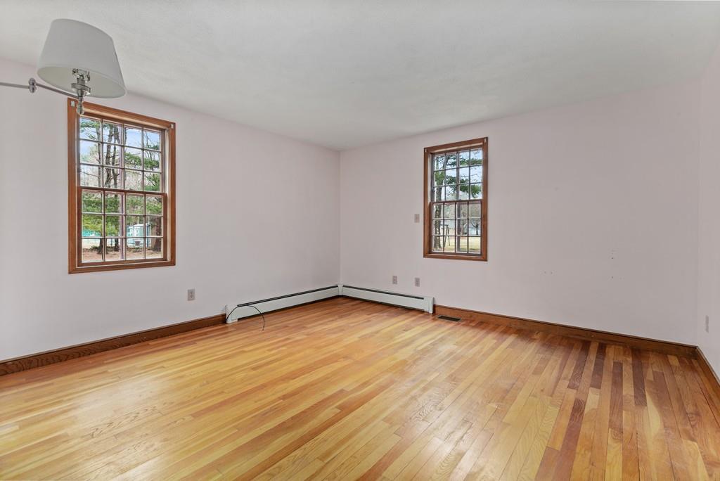 2 Craig Lane Hingham, MA 02043 - Photo 10 of 18 an empty room with wooden floor and windows