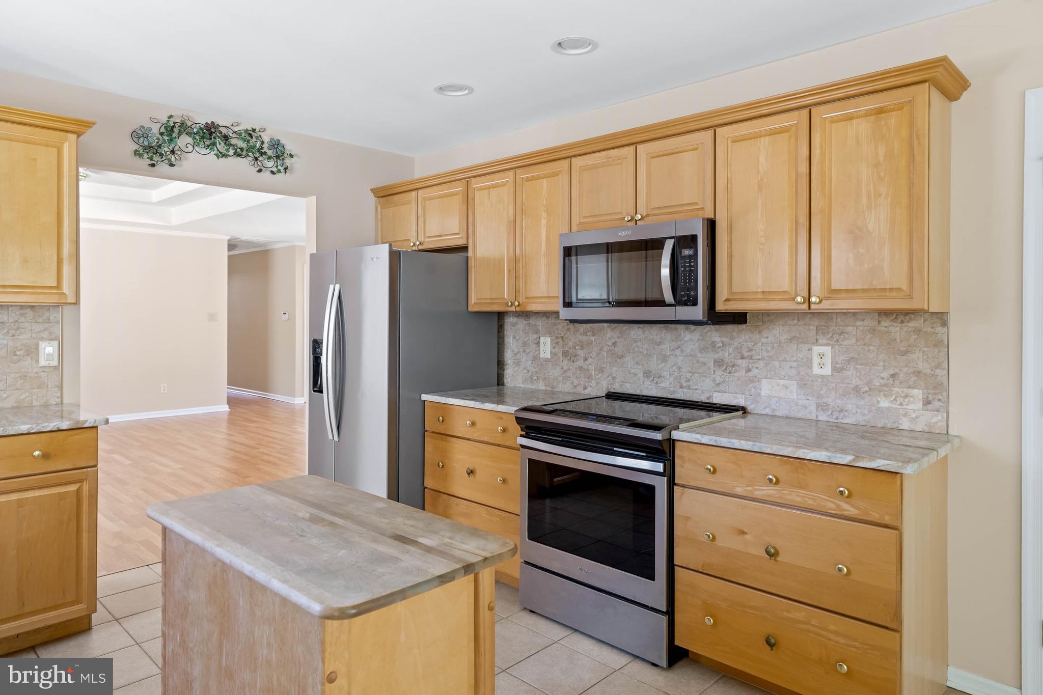 4 Alderleaf Drive Lewes, DE 19958 - Photo 14 of 43 a kitchen with a stove microwave and refrigerator
