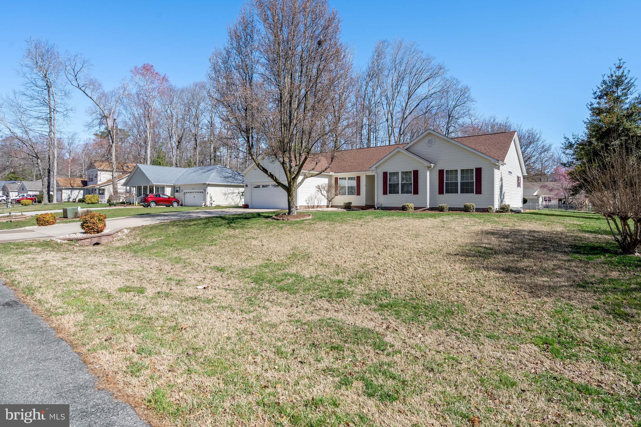 4 Alderleaf Drive Lewes, DE 19958 - Photo 35 of 43 a view of a yard with a house in the background