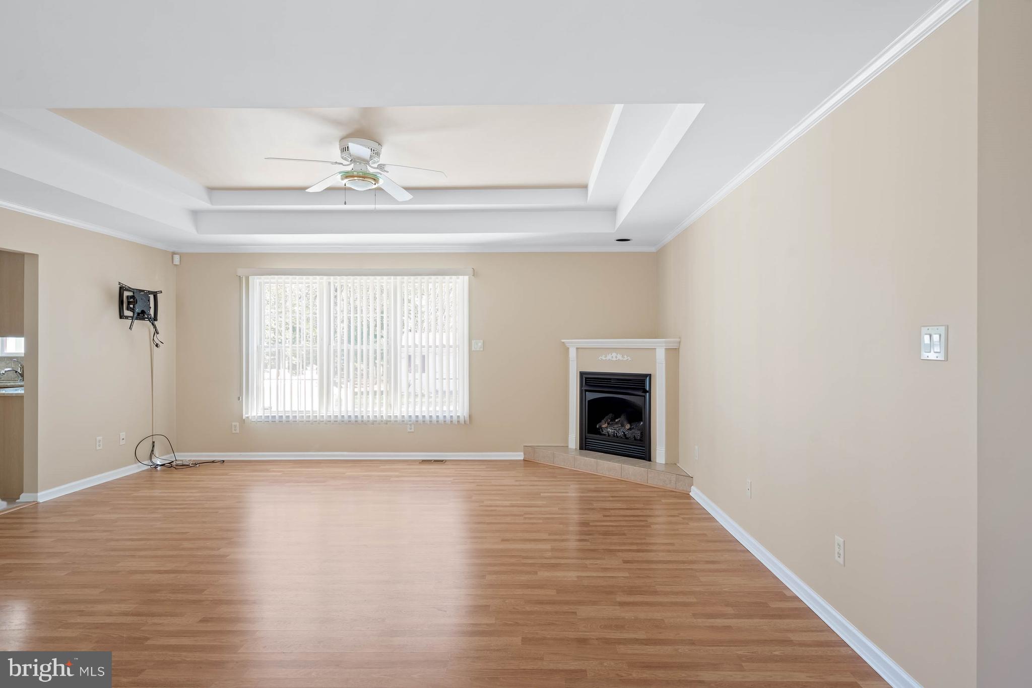 4 Alderleaf Drive Lewes, DE 19958 - Photo 7 of 43 a view of an empty room with wooden floor fireplace and a window