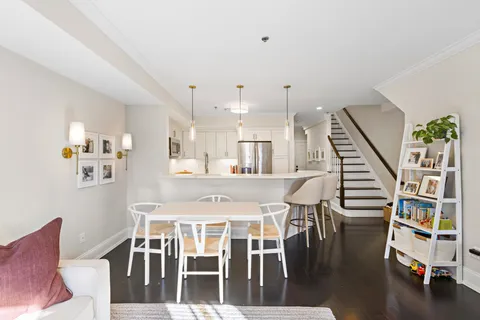 a dining room with furniture and wooden floor