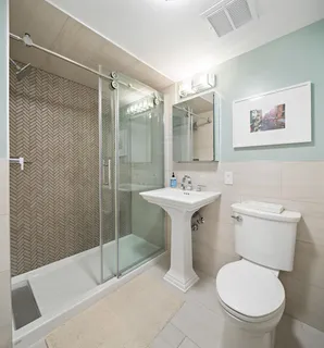 a bathroom with a sink toilet and shower